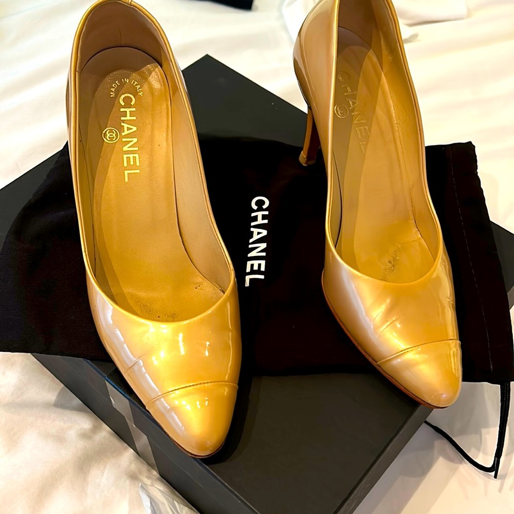 Patent leather gold pump. Worn but still in good condition. Red bottom